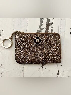kate spade Gold Glitter Wristlet with Black Clover Accent